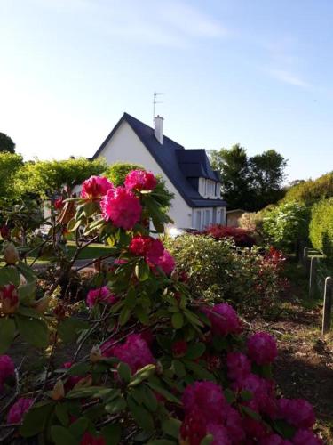 高伊斯瑙Chambre sympa belle propriété的前面有粉红色花的房子