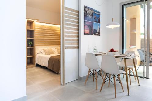 莱斯卡拉Albana Apartaments Turístics的用餐室以及带1张床和1张桌子及椅子的卧室