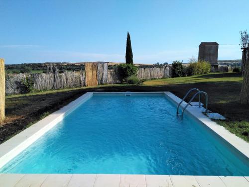 萨拉曼卡Casas Olmo y Fresno jardín y piscina a 17 kilómetros de Salamanca的一个带围栏的院子内的游泳池