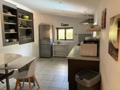 博尼法乔Petite maison de campagne的厨房配有冰箱和桌椅