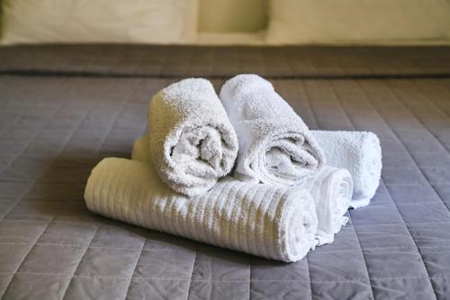 伊佐拉M9 Rooms的浴室地板上的毛巾堆