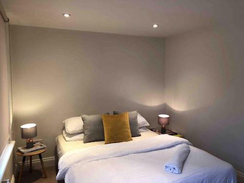 伦敦Central London Charming Camden Split Level Home的一间卧室配有一张大床和两盏灯