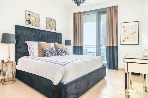 迪拜Dream Inn Dubai Apartments- Burj Vista的一间卧室配有一张大床和一张书桌