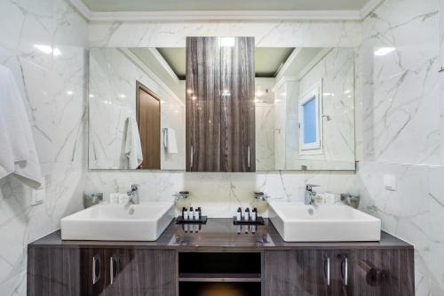卡尼奥提Sunny Villas Exclusive的一间带两个盥洗盆和大镜子的浴室
