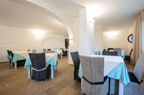 马里纳迪马萨塔文内塔洛奇酒店的大楼内带桌椅的用餐室