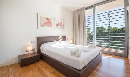 塔马里特Villa Foixarda near Barcelona, TarracoHomes的一间卧室设有一张大床和一个大窗户