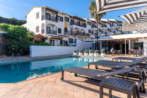 马翁Calallonga Hotel Menorca的一座带游泳池和大楼的酒店
