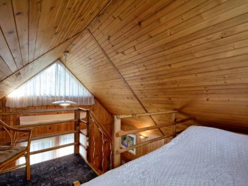 亚斯塔尔尼亚Blisko morza的木制客房内的一间卧室,配有一张床