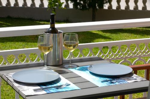 阿穆迪亚科勒套房酒店的一张桌子,上面放有两杯葡萄酒和一瓶