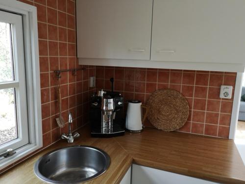 马尔克洛Het Nijhuisje的厨房柜台配有水槽和咖啡壶