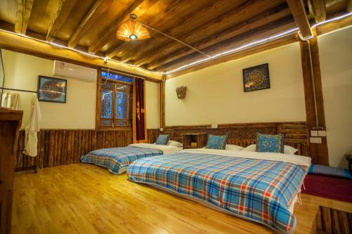 香格里拉香格里拉古城远方的家格萨吉布客栈的一间卧室,配有两张床