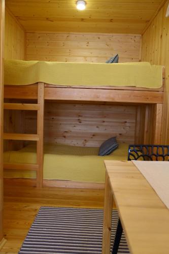 UznezyaАйбарка的小屋内的双层床,配有桌子