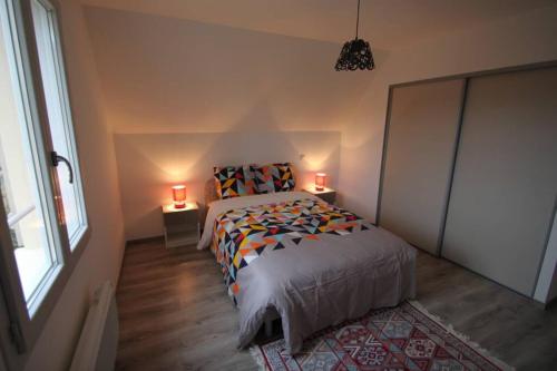 蒙蒂尼亚克Amour Périgord的一间卧室配有一张带两盏灯的床和一扇窗户。