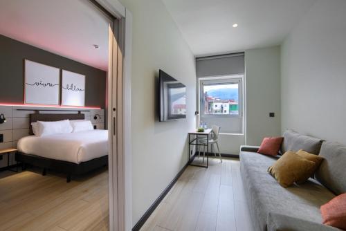 毕尔巴鄂Hotel Bed4U Bilbao的客厅配有床和沙发