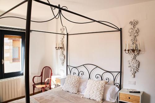 摩拉鲁比罗Vista al Castillo de Mora de Rubielos VUTE-22-036的卧室配有带白色枕头的黑色天蓬床