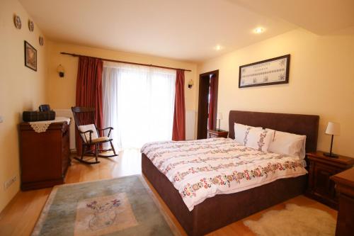 普雷代亚尔特兰西瓦尼亚度假屋的一间卧室配有一张床、一张书桌和一个窗户。