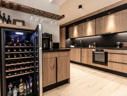 萨尔巴赫FRAU GANS - pure mountain apartments的厨房配有木制橱柜和冰箱。