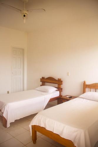 科曼达图巴岛Pousada Pau Brasil的一间卧室设有两张床和天花板