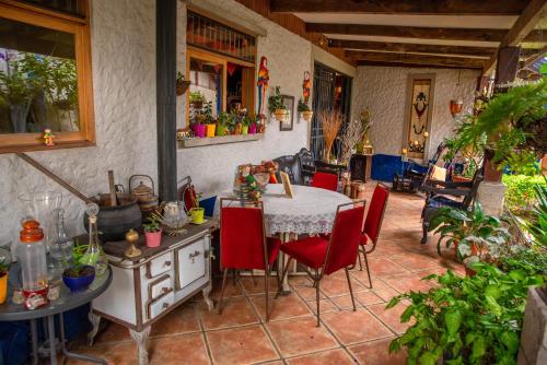 迦太基La Casa de Mamá Coyita的厨房配有桌子和红色椅子