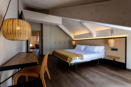 莫利纳塞卡No-Mad Green Hotel的一间卧室配有一张床、一张桌子和一张书桌