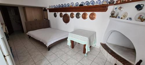 斯基罗斯岛Mini Traditional House的墙上有桌子和盘子的房间