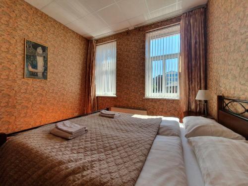 利耶帕亚阿凡塔酒店的一间卧室设有一张大床和两个窗户。