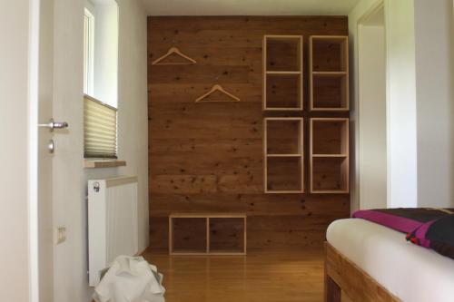 MildenauFerienwohnung Friedrich的一间卧室设有木墙和衣架