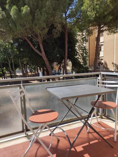 佩萨罗Rossetto e cocciolato - Stanza indipendente con bagno privato a Pesaro的阳台配有一张桌子和两把椅子