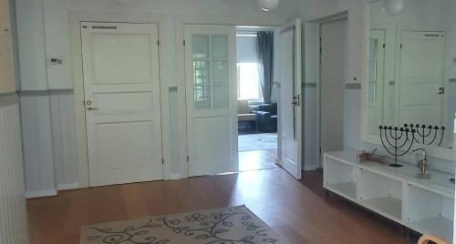 海门林纳Vääpeli的客厅设有白色门和木地板
