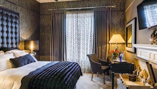 莫法特Ram Lodge的配有一张床、一张书桌和一扇窗户的酒店客房