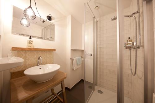 罗伊特丹宁霍夫酒店的白色的浴室设有水槽和淋浴。