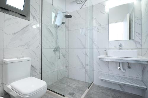 科孚镇Marina Vista Luxury Studio suites Beach front的白色的浴室设有卫生间和水槽。
