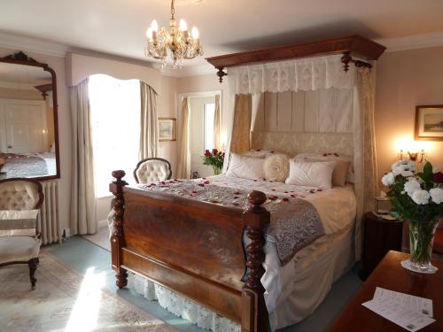 波特兰安妮女王之家住宿加早餐旅馆的一间卧室配有一张带天蓬的大床