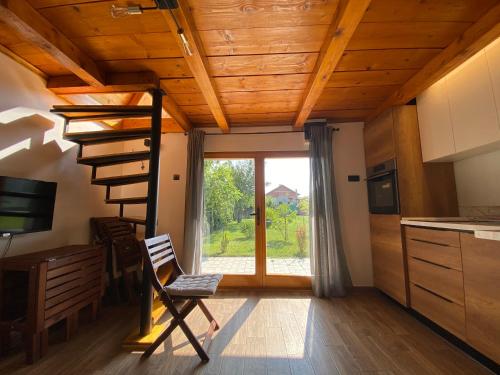诺维萨德Petrovaradin Chalet的一间带木制天花板和螺旋楼梯的厨房