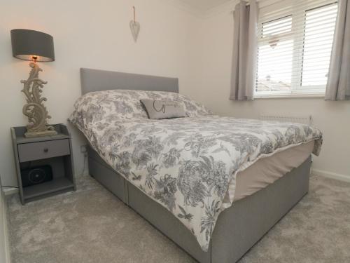 布里德灵顿Iris的一间卧室配有一张带毯子和灯的床