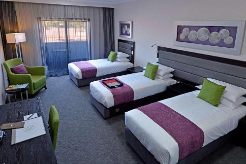 达尔文帕默斯顿莱吉斯酒店客房内的一张或多张床位