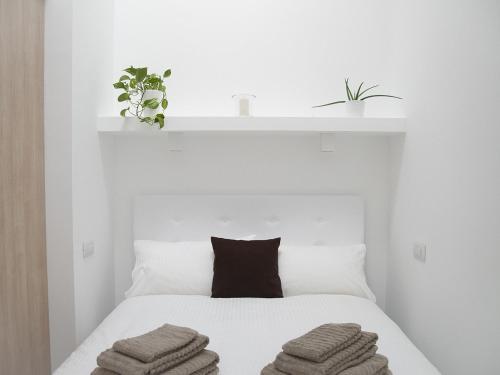米兰Brand new apartments Ortiquattro的白色卧室,配有带毛巾的床