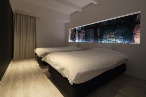 鸣泽市abrAsus hotel Fuji的一间卧室设有两张床,墙上挂着一幅大画