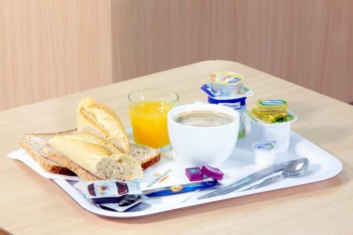 索肖普瑞米尔蒙贝利雅得索尚经典酒店的早餐盘包括烤面包和一杯橙汁