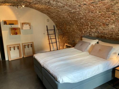 乌得勒支De Hoendervorst的卧室配有砖墙内的床铺