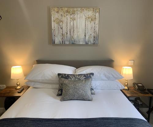 BellwayThe Cedar Country Hotel的一间卧室配有带白色床单和枕头的床。
