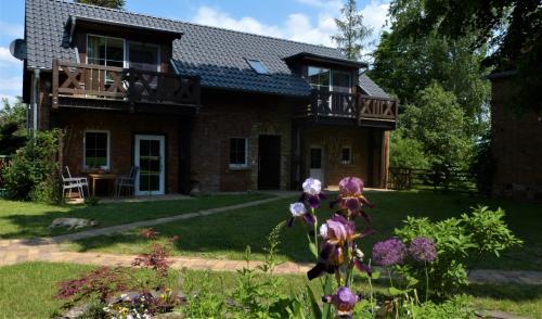 韦尔本Ferienwohnung im Spreewald in idyllischer Alleinlage的带阳台的砖屋,并有鲜花