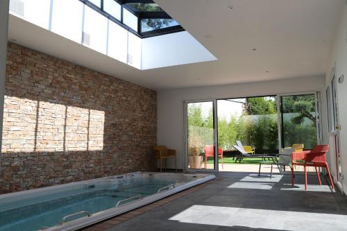 瓦讷Appart hôtel & Spa La Villa du Port的砖墙房间的游泳池