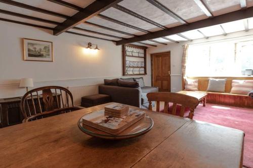 哈德斯菲尔德Clay Well Cottage的客厅配有桌子和沙发
