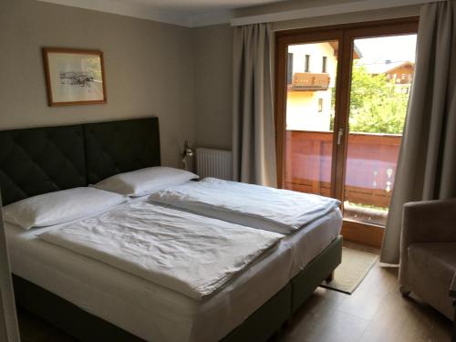 滨湖采尔Appartement Kitzsteinhorn的一间卧室设有一张床和一个大窗户