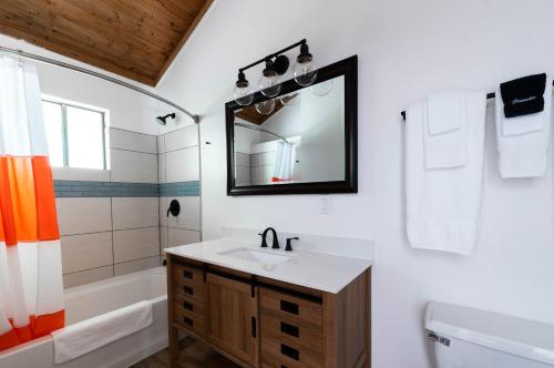 Monte RioCasa Secoya的一间带水槽、浴缸和镜子的浴室