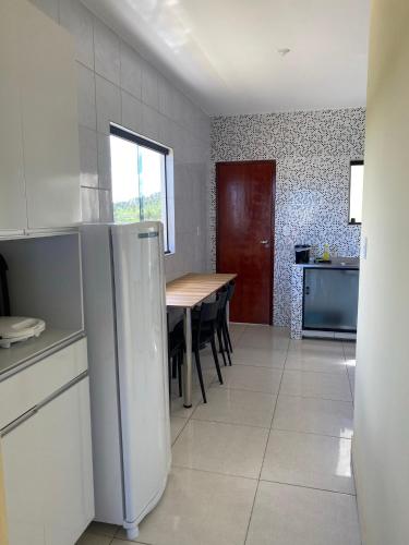 马拉戈日Mellim Residence的厨房配有桌子和冰箱。