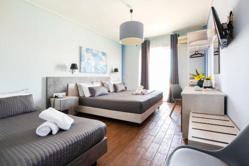 马蒂米尔托酒店的一间卧室配有两张床和电视。