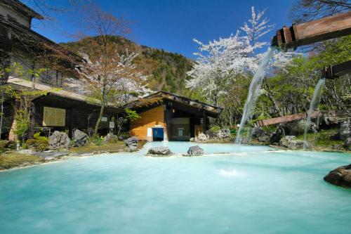 松本泡汤旅馆的一座房子前面的喷泉水池