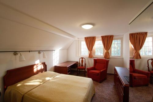 巴拉顿博格拉尔巴拉同柏格拉塔特别墅酒店的卧室配有一张床、一张桌子和椅子